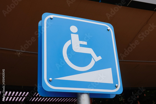 Blue Handicap at parking car sign outdoors for Disabled, Wheelchair or elder old or cannot self help people.