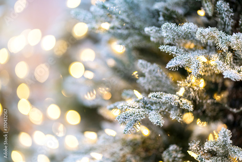 close up christmas tree with snow and light decorating with blur bokeh background © whyframeshot