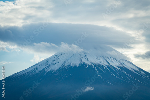 Peak of mountain Fuji wearing hat in the cloudy day.