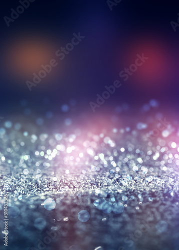 Abstract background. Defocused lights of the night city. Brilliant festive background with neon glow.