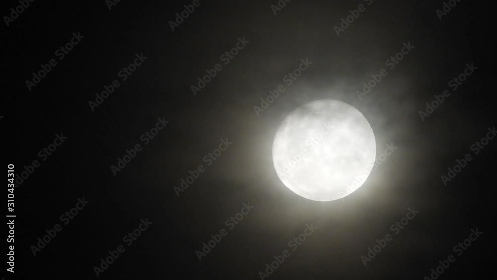 Haunted full moon with eerie dark clouds moving past in the foreground, perfect for halloween or scary video transitions. Haunted full moon with eerie dark clouds moving past in the foreground, perfect for halloween or scary video transitions.