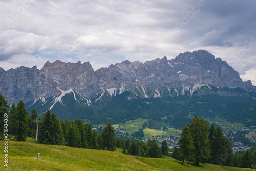 View of Cortina D'Ampezzo at distance with Monte Cristallo mountains on background, tourism travel concept, copy space, day. Italy, South Tyrol.