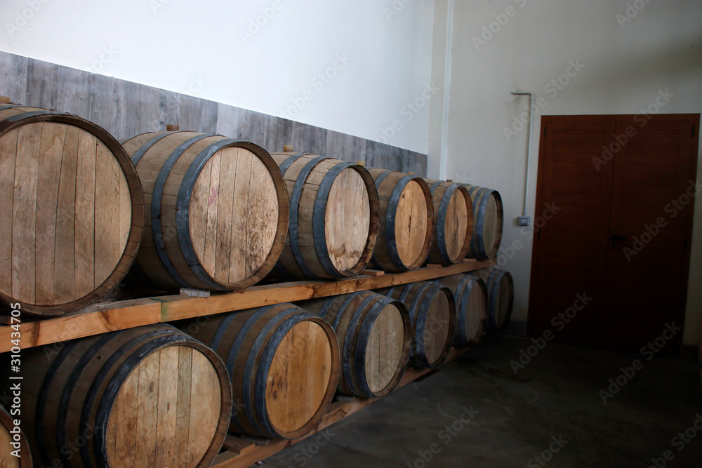 Wine barrels piled on a room Wine barrels piled on a room