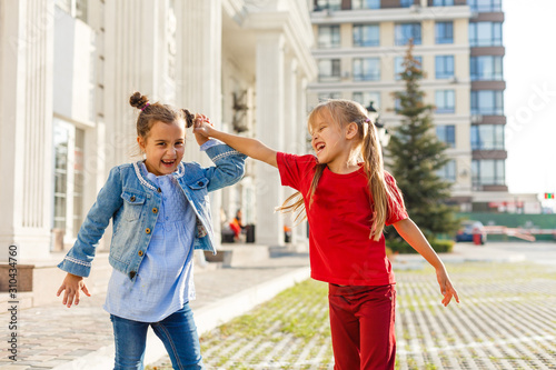 two little girls dancing in the street