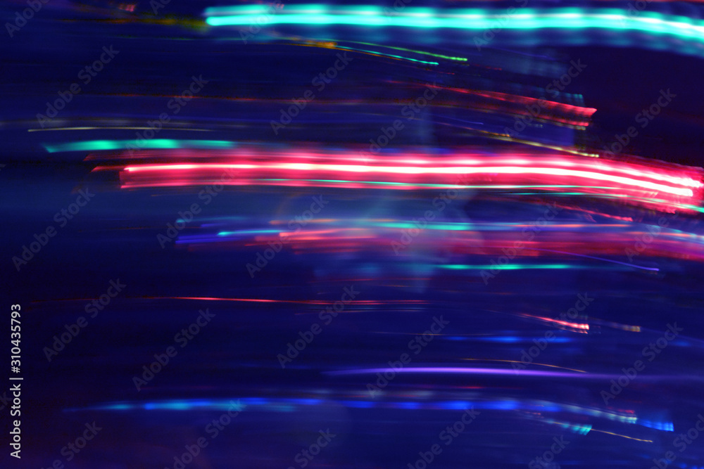 Abstract Multicolored Light Motion of Wavy and Round Line Trails Background. Glowing and Bright Neon Colors. For Disco, Celebration, New Year, Night Rave, Party Abstract Multicolored Light Motion of Wavy and Round Line Trails Background. Glowing and Bright Neon Colors. For Disco, Celebration, New Year, Night Rave, Party