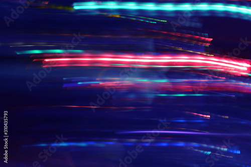 Abstract Multicolored Light Motion of Wavy and Round Line Trails Background. Glowing and Bright Neon Colors. For Disco, Celebration, New Year, Night Rave, Party