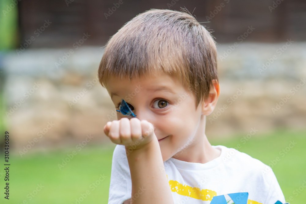 Little Boy Making Funny Face And Looking Dragonfly Little Boy Making Funny Face And Looking Dragonfly