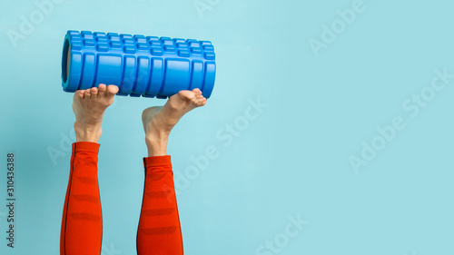 Young woman ready to do Fascia Training holding a Fascia Roll