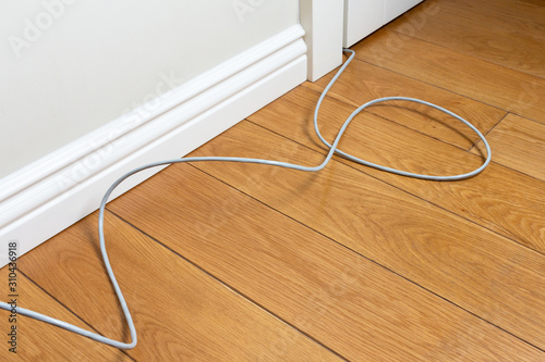 internet cable on the wooden floor of the room
