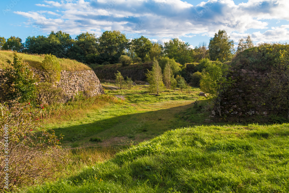 Stone walls and moats covered by the grass in Annenkrone in sunny day, Vyborg, Leningrad Oblast, Russia