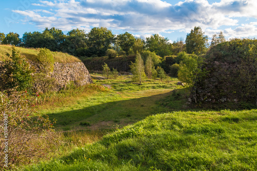 Stone walls and moats covered by the grass in Annenkrone in sunny day, Vyborg, Leningrad Oblast, Russia photo