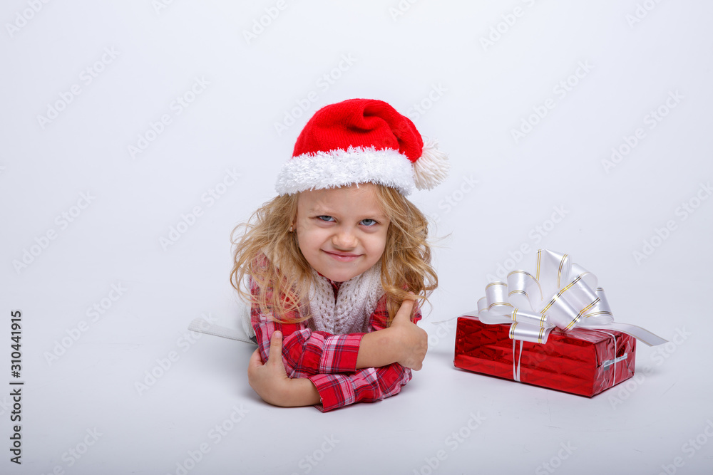 little girl in Santa hat lying on white background isolated on white background little girl in Santa hat lying on white background isolated on white background