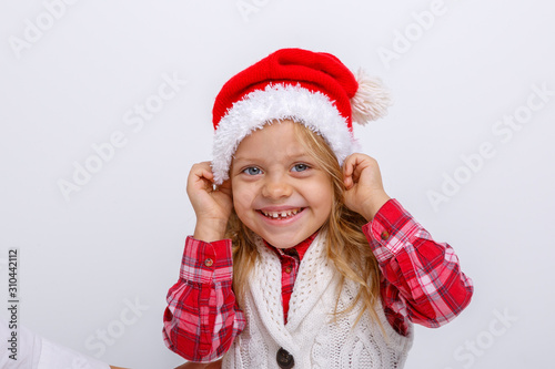 cute happy little girl in santa claus hat. Santa s helper on a white background