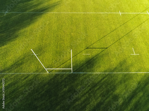 Aerial view on a goal posts to practice soccer, football, rugby and Irish national sports hurling and comogie. Empty field, sunny day.