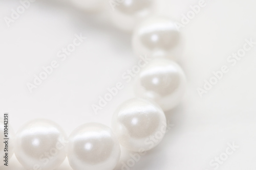 Necklace with shining white pearl isolated background macro