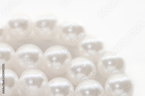 Necklace with shining white pearl three layers isolated background macro