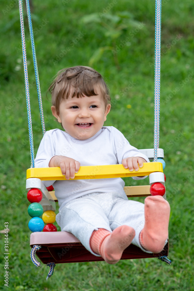 Happy beautiful child on swing