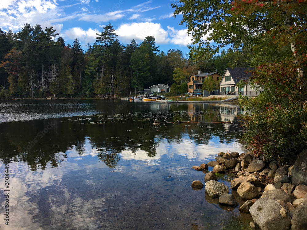 Houses with boat ramps on lake in autumn