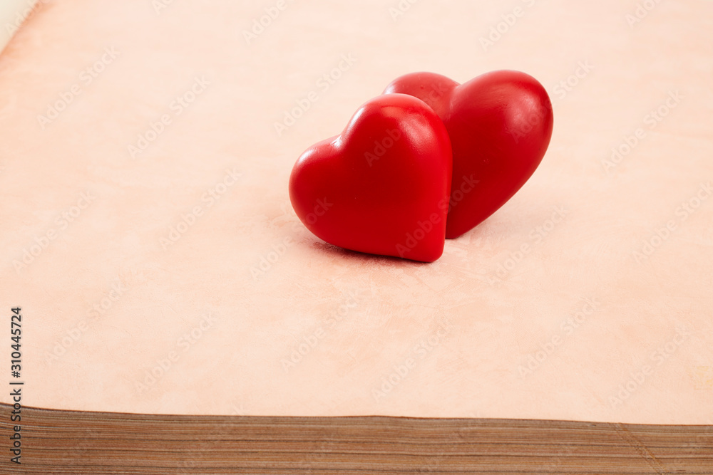 Two red hearts on Pink background