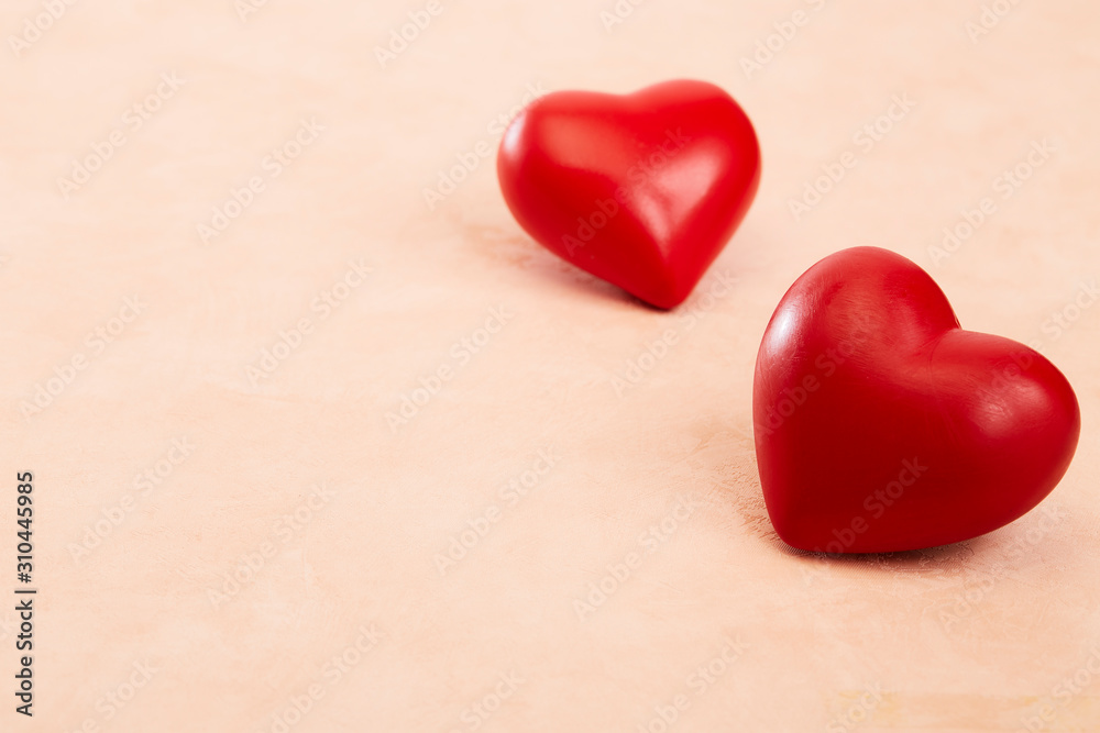 Fototapeta premium Two red hearts on Pink background