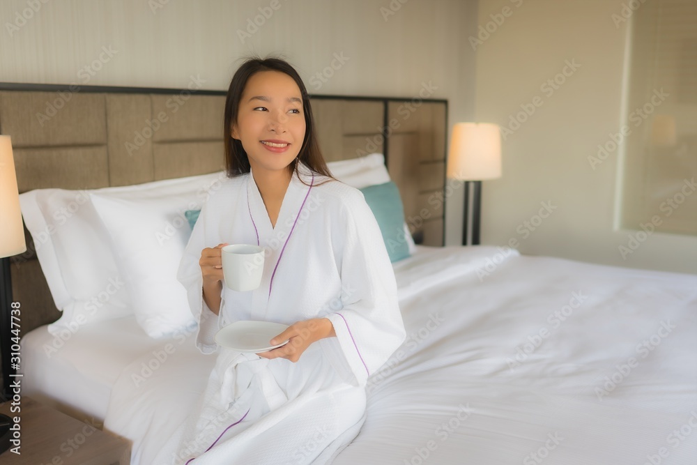 Portrait beautiful young asian women with coffee cup on bed Portrait beautiful young asian women with coffee cup on bed