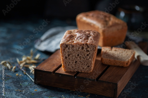 Sourdough bread. Sliced rye bread on a dark background. Healthy eating concept.