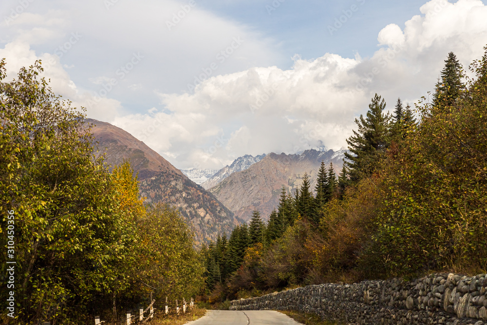 The mountain  road runs between the mountains in Svaneti in the mountainous part of Georgia