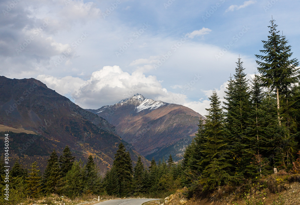 The mountain  road runs between the mountains in Svaneti in the mountainous part of Georgia