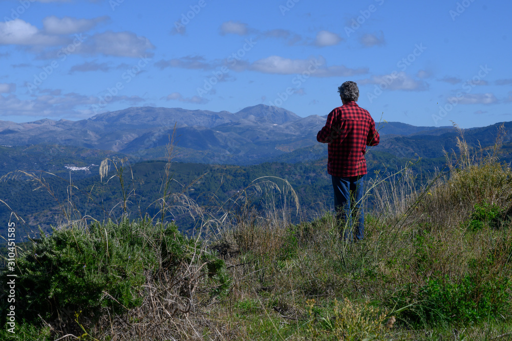 Rear view of man looking at view, Algatocin, Malaga, Andalusia, Spain