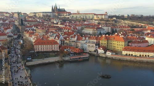 Aerial view of Charles Bridge and Prague Castle at sunset light in desember in Prague, Czech Republic photo