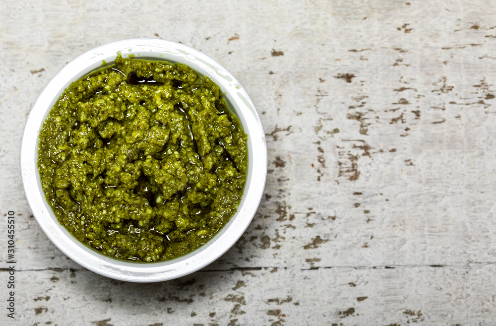 Pesto.Traditional italian homemade pesto dip on white background Pesto.Traditional italian homemade pesto dip on white background