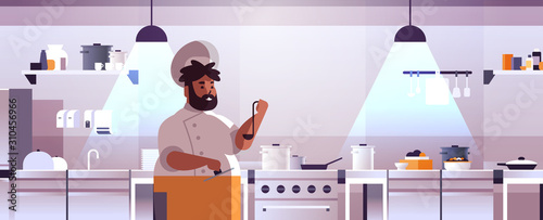 male professional chef cook preparing and tasting dishes african american man in uniform near stove cooking food concept modern restaurant kitchen interior flat portrait horizontal vector illustration