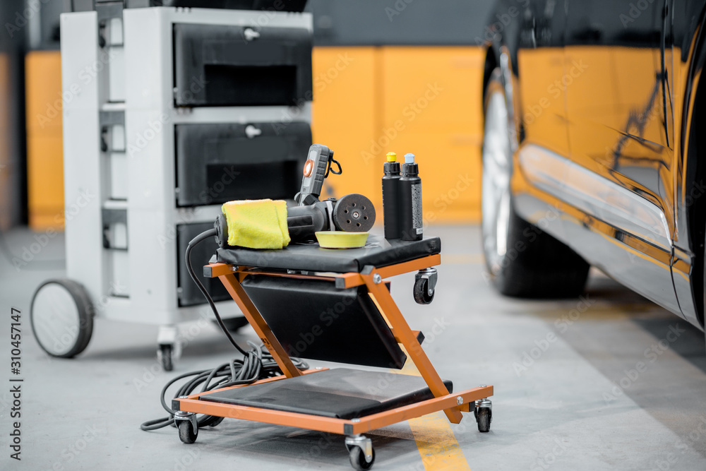 Professional equipment for automotive body polishing at the car service. Car detailing tools for vehicle care Professional equipment for automotive body polishing at the car service. Car detailing tools for vehicle care