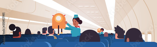 stewardess explaining for passengers how to use jacket life vest in emergency situation african american flight attendants safety demonstration concept modern airplane board interior horizontal vector
