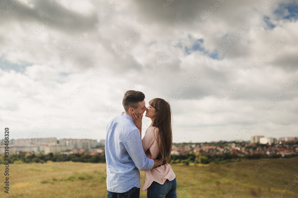 Young couple outdoor portrait. Beautiful pretty girl kissing handsome boy. Sensual photo. Young couple outdoor portrait. Beautiful pretty girl kissing handsome boy. Sensual photo.