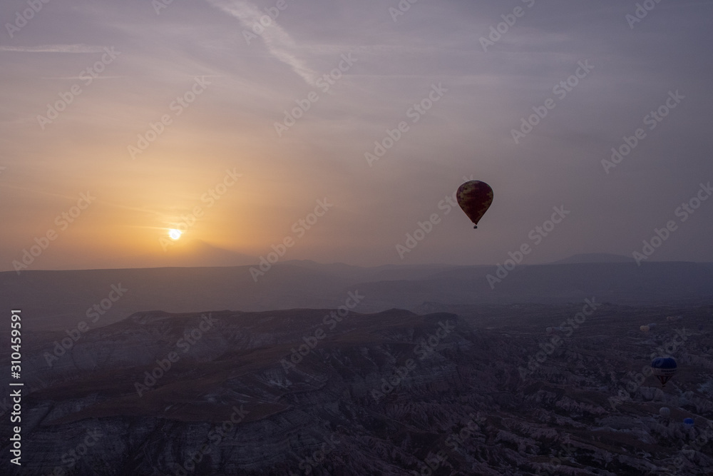 Hot air balloons over mountain landscape in Cappadocia Basket, levitation on October