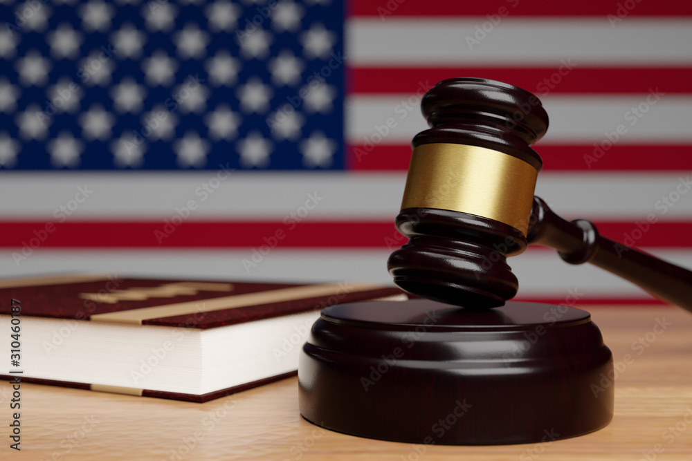 Judge's hammer and book of law on a wooden surface on the background of the flag of the United States of America.3D render.