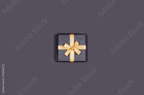 Greeting card. Grey background with gift box. Place for the text. Central composition. © Aleksandra Abramova