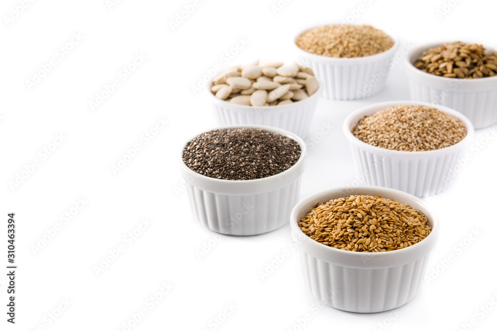 Assortment of different seeds in bowl isolated on white background. Pumpkin, linen, chia, sunflower, and sesame seeds Assortment of different seeds in bowl isolated on white background. Pumpkin, linen, chia, sunflower, and sesame seeds