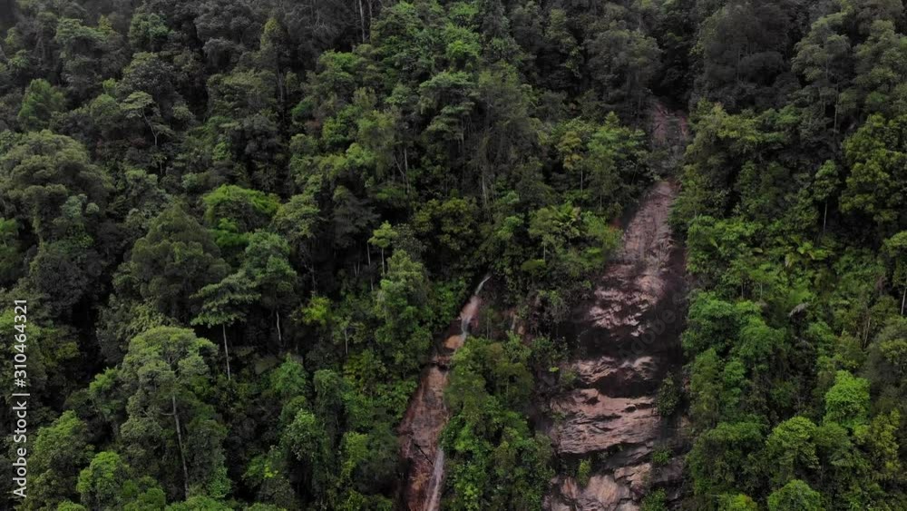 Scenic aerial view of waterfall at hills surrounded by forest Scenic aerial view of waterfall at hills surrounded by forest