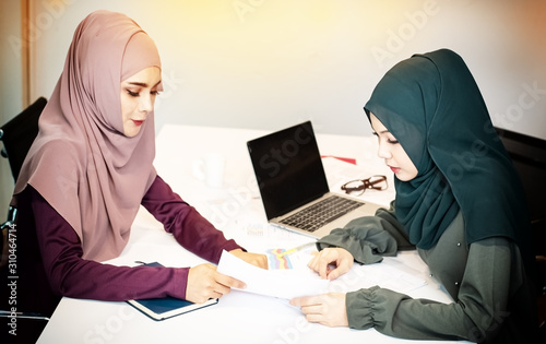 The muslim business woman doing paper work together,at meeting room,office busy time,