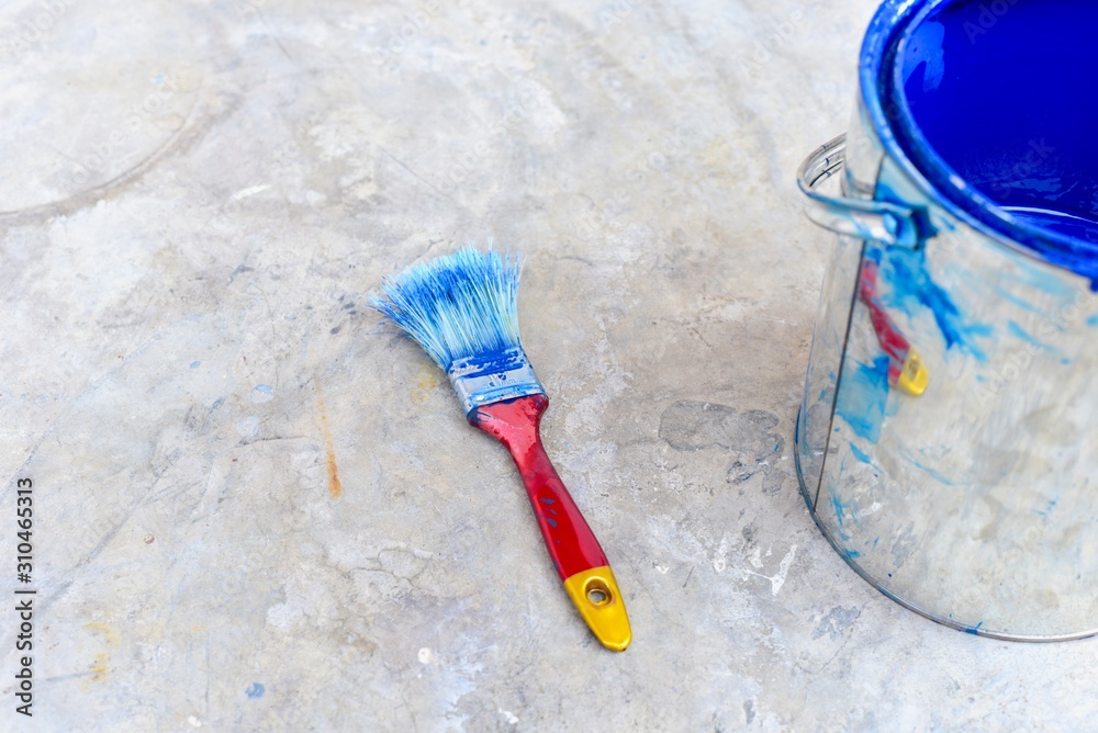 Paint Brush Isolated on Floor with Paint Bucket