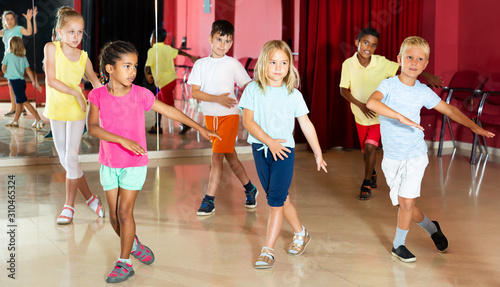 Boys and girls having dancing class in studio