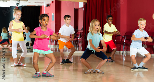 Nice children rehearsing movements of ballet