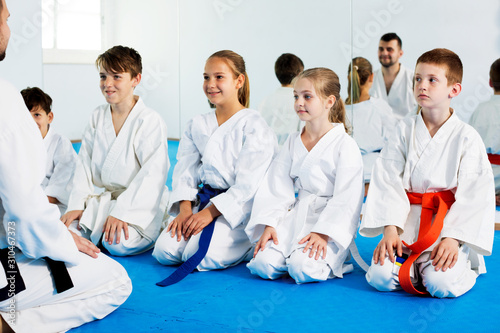 Children enjoying their trainings with coach at karate