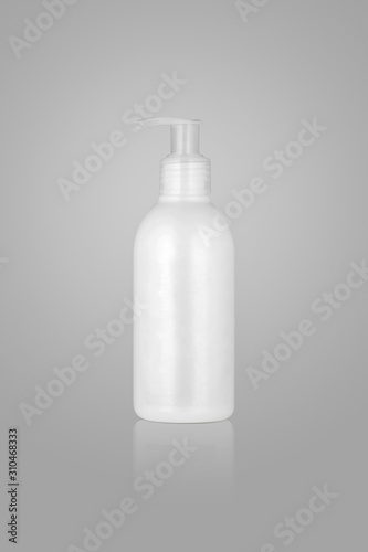 cosmetic container with pump on light background. bottle with gel
