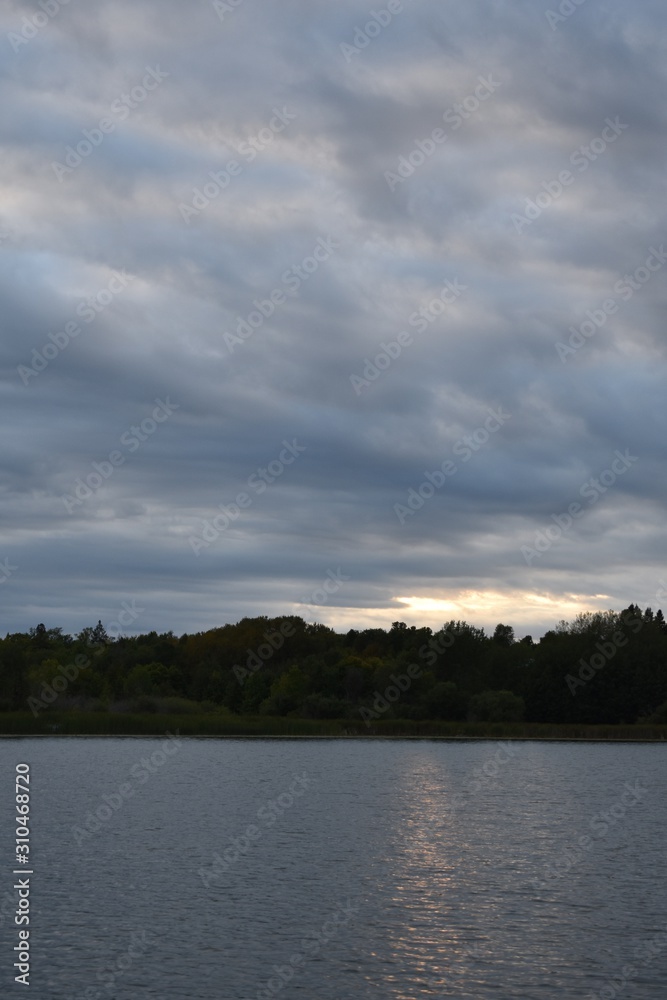 Stormy clouds and sunset over the water