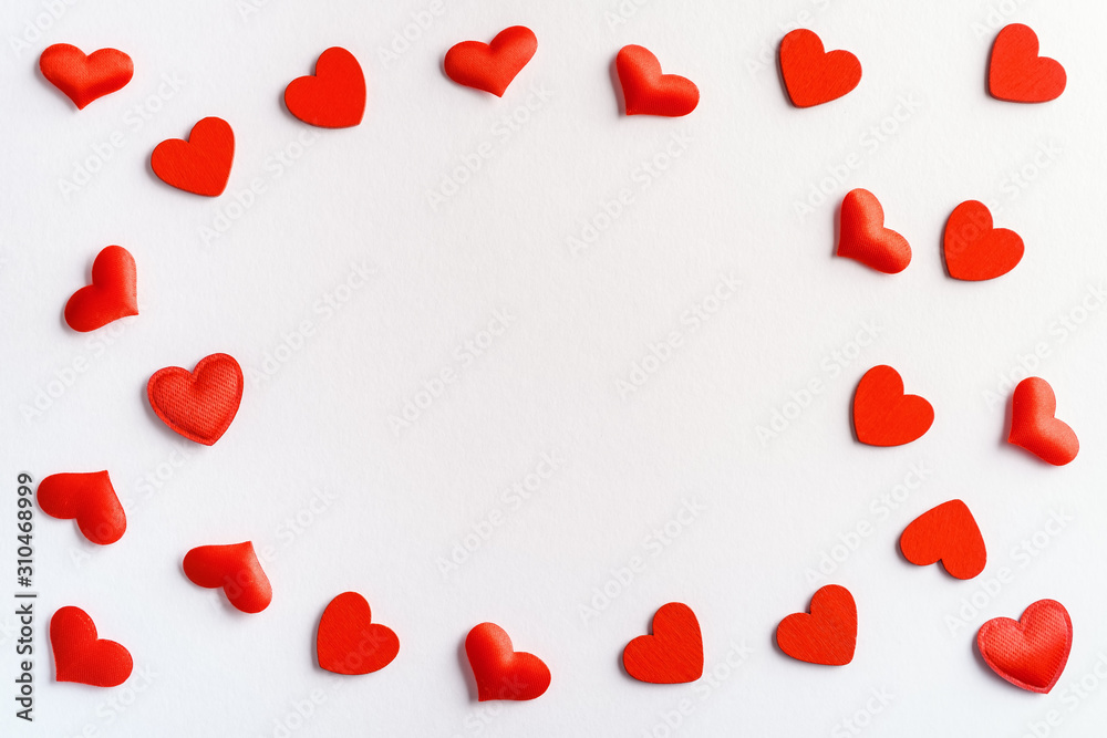 Festive composition from red hearts scattered on white background, valentines day concept, copy space for text