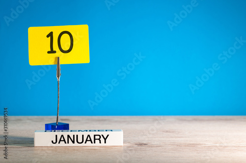 January 10th. Day 10 of january month, calendar on blue background. Winter time. Empty space for text, mock up photo