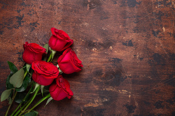 Red rose flowers bouquet on wooden background Valentine's day greeting card Copy space Top view